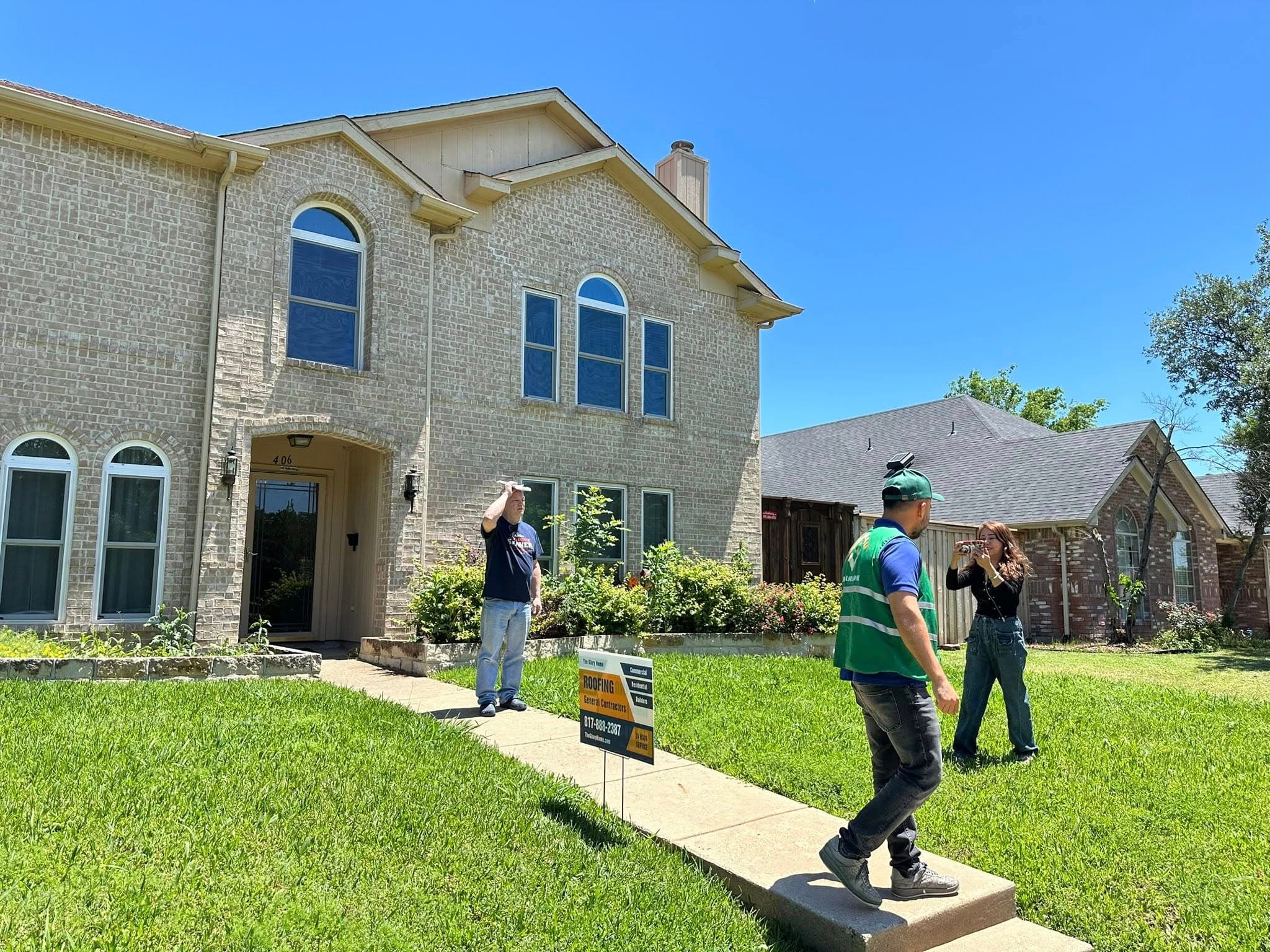 Glory Home crew reviewing a residential roofing project